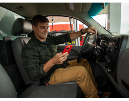 an HVAC worker uses a mobile phone with WEX FSM for social media marketing for hvac business