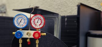 Close up of manifold gauges used for checking air conditioner refrigerant in need of maintenance. Set of barometer high or low freon levels benchmarking hvac system component