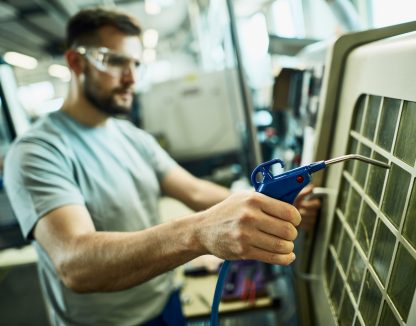 an hvac technician working on an ac unit