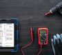 Composition with digital tablet and electrician work items, top view.
