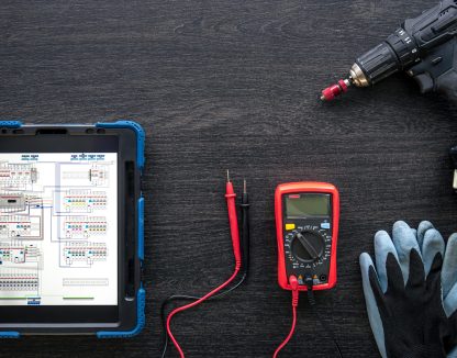Composition with digital tablet and electrician work items, top view.