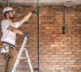 Electrician with tools, working on a construction site. Repair and handyman concept. House and house reconstruction. SSUCv3H4sIAAAAAAAACpyRz27DIAzG75P2DhHnRmr+ttmrVDs44CaoFCogm6aq7z4DYeK8G/7Z/uzPPN/fqorN4CRnH9UzRBRLpTbnLXhpNOHjYecWtUBbEhTSGytBlXAGz1cNdySoN6UCfsUkcx785tCFYTvi4HEhjQT/JNJGlxRXORGT1EEpxg4Fc9scWUZJ/F+d6fGZ3cCCmv/EhQsjFhVCMnJJpez27dHeS2uwCWkKV1+GgwoFXaH0sJJLvRRtxq/xyrmNm017G1ZgbTPl5Zky5gGzCle+kixmvoJz1CEyL2Zx+lZzL0Zp46OH/SRM0GeEsOnapm+HYTr14+lEUbcXpA9cJenEjbIQxfwmRelehg3YNJ6vneBT3R3bse4HMdZwPkLNkUPTNu25GZBu//oFAAD//wMAxplQV4oCAAA=