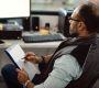 an HVAC business owner looks HVAC insurance paperwork