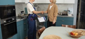 a plumber shakes hands with a plumbing lead that now is a customer