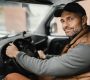 an hvac plumbing technician wearing a vest drives a work van, the text reads customer spotlight: how Leigh's heating and cooling succeeds with WEX FSM