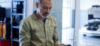 Mechanic using digital tablet in repair shop