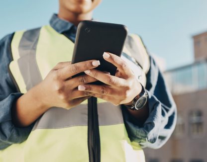 Phone, construction worker hands and person typing, networking or search info about inspection, maintenance or building. Cellphone communication, closeup builder or engineer research architecture.
