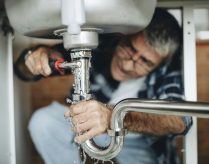plumber contractor working on customer's sink