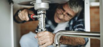 plumber contractor working on customer's sink