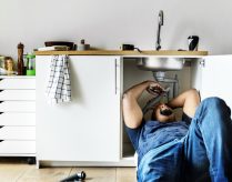 Plumber man fixing kitchen sink