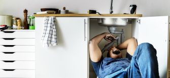 Plumber man fixing kitchen sink