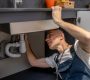 Plumber, repair. Experienced attentive middle-aged man carefully examining bottom of kitchen sink touching pipe with his hand diagnosing problem SSUCv3H4sIAAAAAAAACnRSQU7DMBC8I/GHyOdGSuskJf0BBwT3isPG3ramrl3ZThGq+DvrOEY+wC07szs748398aGq2AheCbar7rGiWmk9+eAgKGsIblYL7tBIdCVyc7xvSgClCtYp0CU4QhAnAxck0ExaR/h7JpkPECaPPm5fIAEBj6SRwF+JZHGf6ioTM0kTRLFnE9Ap6zxbFaSfxki+jh8ogmeZScv+UXpDe9X4l8yL8gK1BoN2KsTSx3sODEc04mvOVGR1qBFS1n1qZedPsnwp08MklS2C36wAHRt4oXR1SihzLMZsOM2XyWPCTia4aIHlGExbe4WRcu2qA2lixk/gPbXLjBeLBP0H9lLsMTbMARZVJulYsVzzzRMf+NB3XbvhfbtdLw3pwCdFOrOdLES1OCtZRlfRAdvIrYRDu61F0/O6HUHUwwBQd13Hh0PT4yg5Pfz3DwAAAP//AwCsHV1xuwIAAA==