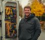 plumber-standing-fully-equipped-work-van-showcasing-organization-readiness