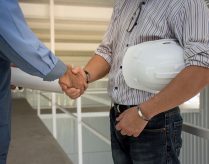 professional-engineering-team-with-white-helmet-shaking-hands-each-other