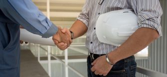 professional-engineering-team-with-white-helmet-shaking-hands-each-other