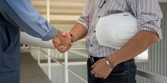 professional-engineering-team-with-white-helmet-shaking-hands-each-other