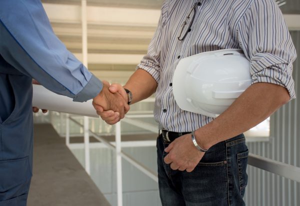 professional-engineering-team-with-white-helmet-shaking-hands-each-other