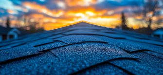 A roof with a sunset in the background.