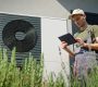 an hvac technician uses a mobile tablet next to an air conditioning unit. The text reads customer story: Guidry’s Air Conditioning & Refrigeration Service