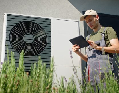 an hvac technician uses a mobile tablet next to an air conditioning unit. The text reads customer story: Guidry’s Air Conditioning & Refrigeration Service