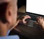 unrecognisable-casual-man-typing-laptop