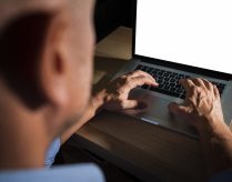 unrecognisable-casual-man-typing-laptop