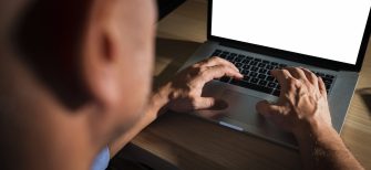 unrecognisable-casual-man-typing-laptop