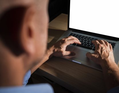 unrecognisable-casual-man-typing-laptop